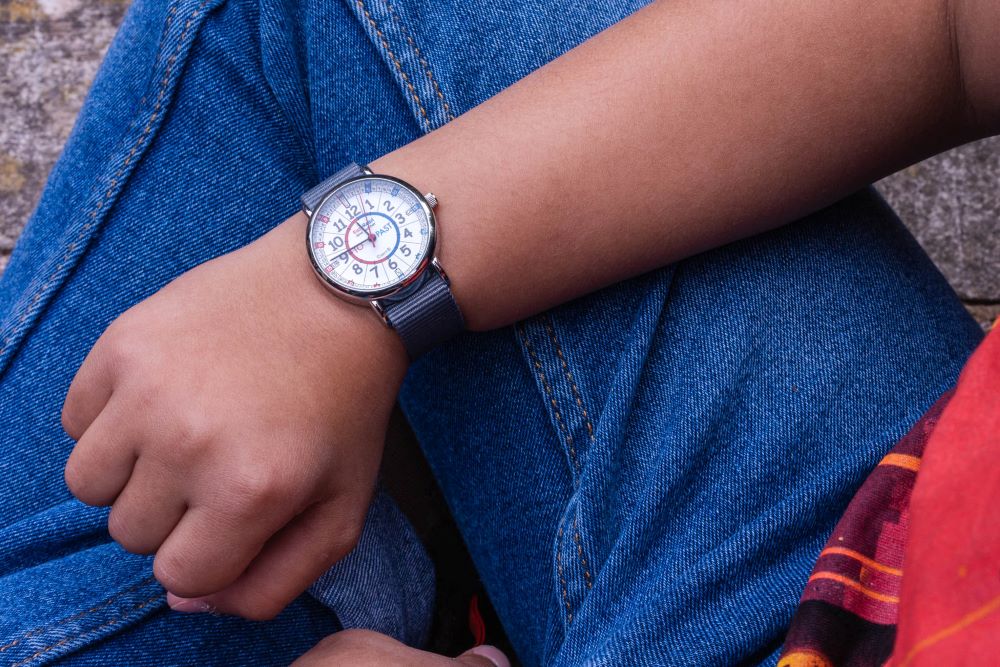 grey strap watch with red and blue face